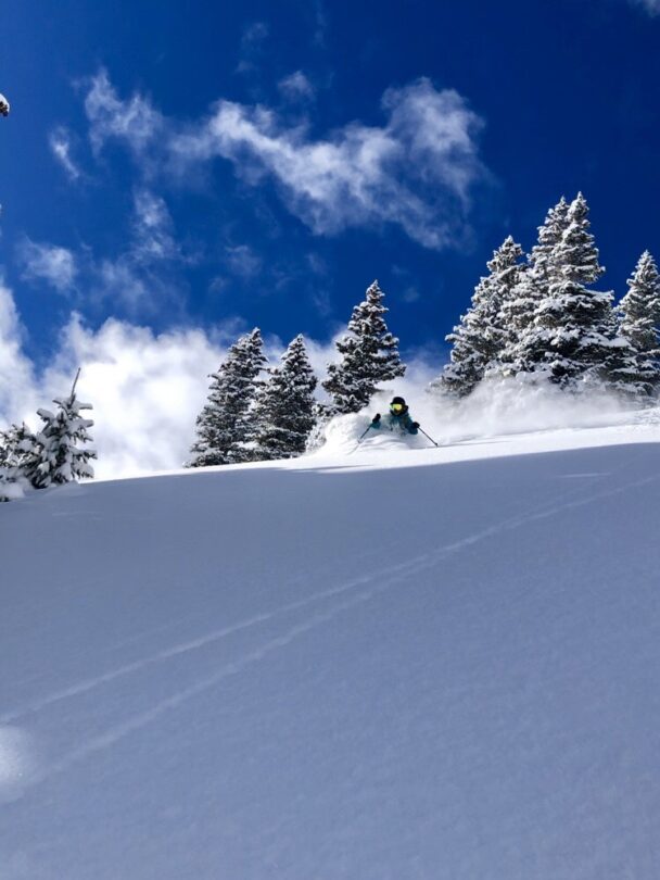 A skier enjoying the dawn from Telluride's snowy backcountry