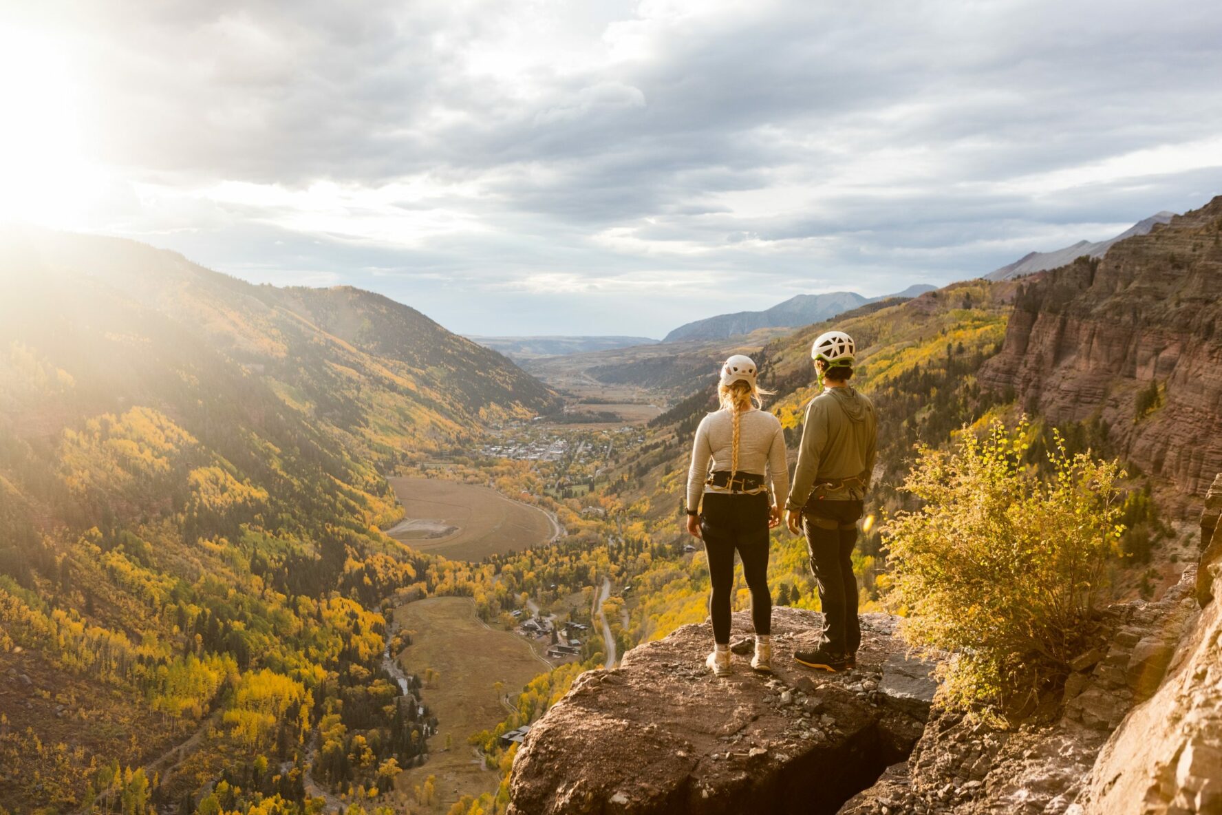 Man and woman posing on a boulder in Telluride, Colorado