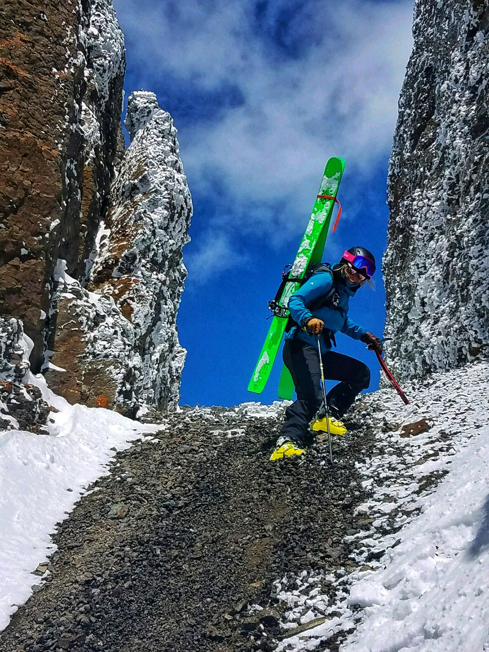 In order to ski, this skier first has to climb the mountains due to the various terrain