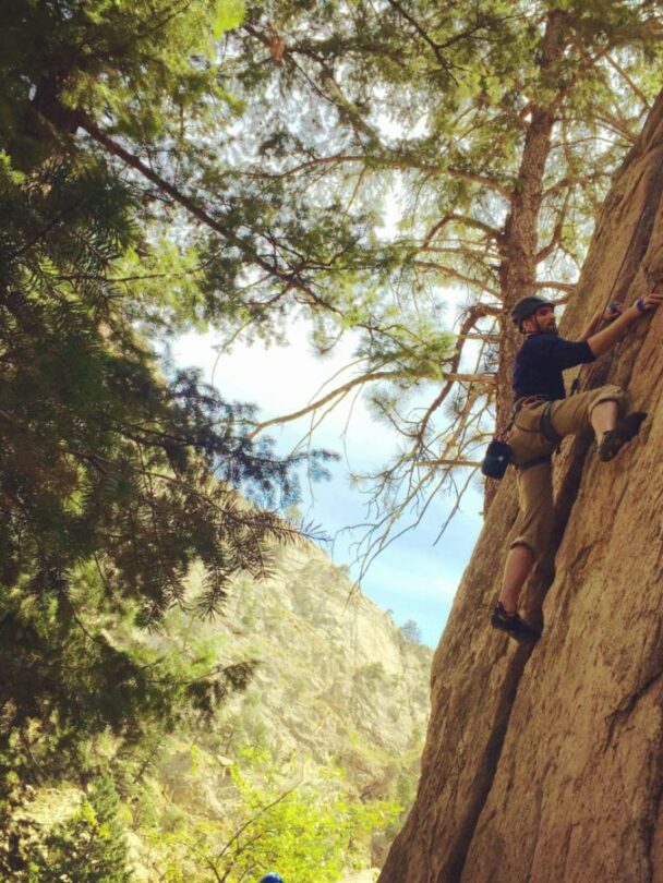 A woman climbing a cliff in Colorado