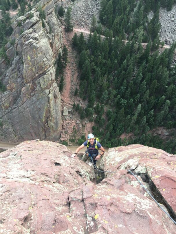 A woman climbing a cliff in Colorado