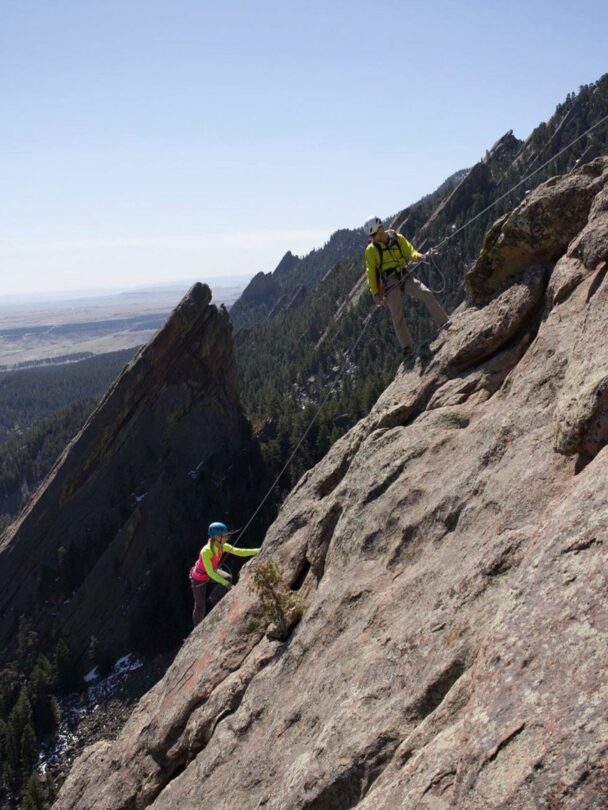 A woman climbing a cliff in Colorado