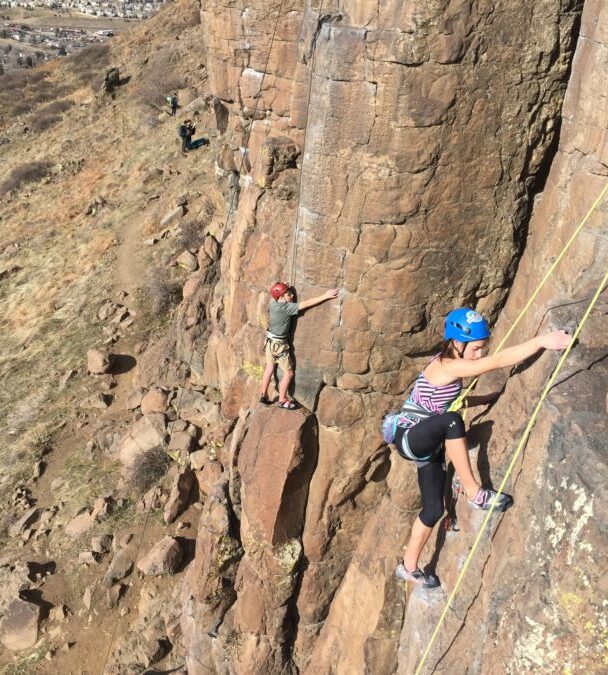 A woman climbing a cliff in Colorado