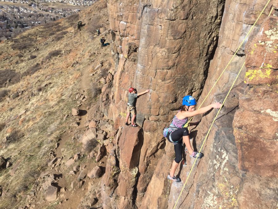 Two people climbing up steep cliffs in Tabletop