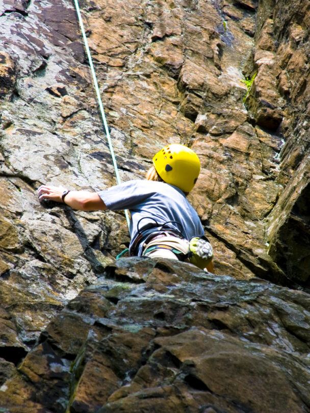 A woman climbing a cliff in Connecticut