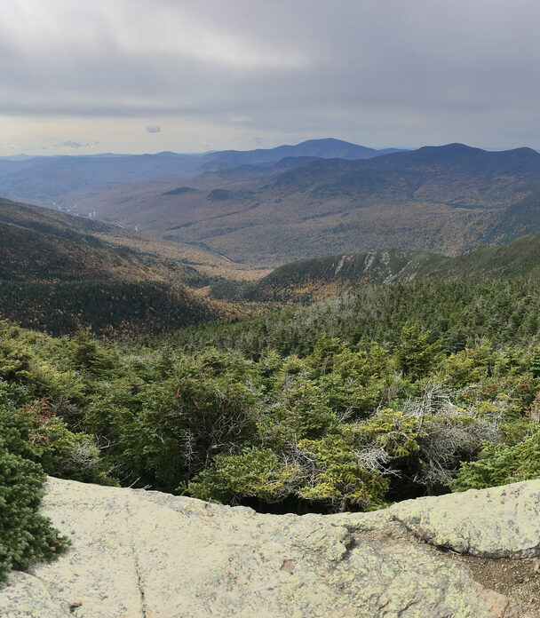 Man standing on the Mount Washington Summit