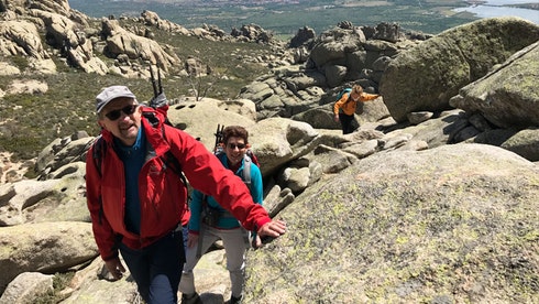 Some hikers ascending the Guadarrama Mountains