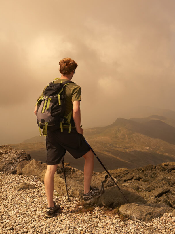 Man standing on the Mount Washington Summit