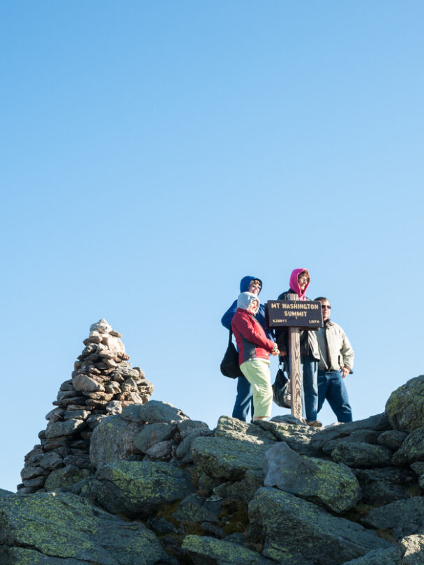 Man standing on the Mount Washington Summit