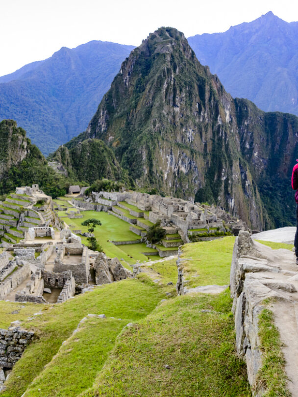 Woman standing in front of Machu Picchu