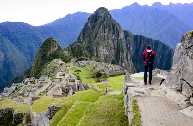 Woman standing in front of Machu Picchu