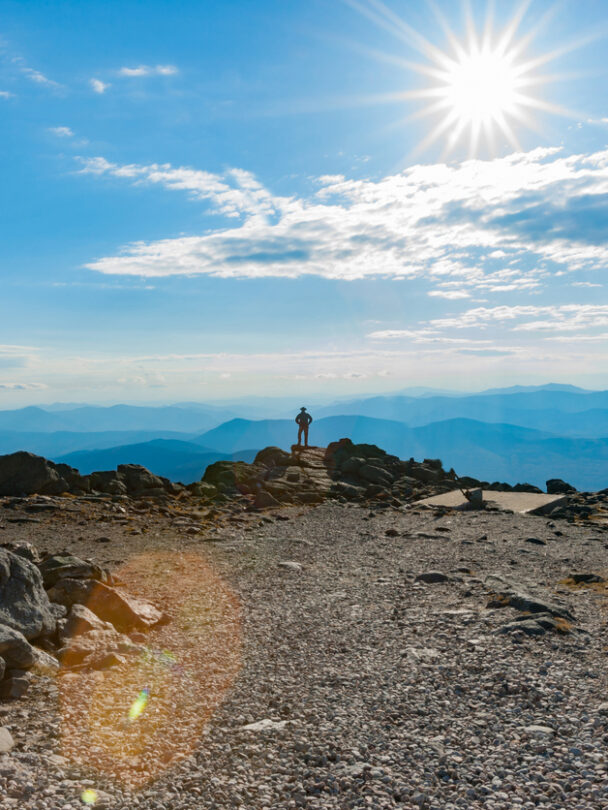 Man standing on the Mount Washington Summit