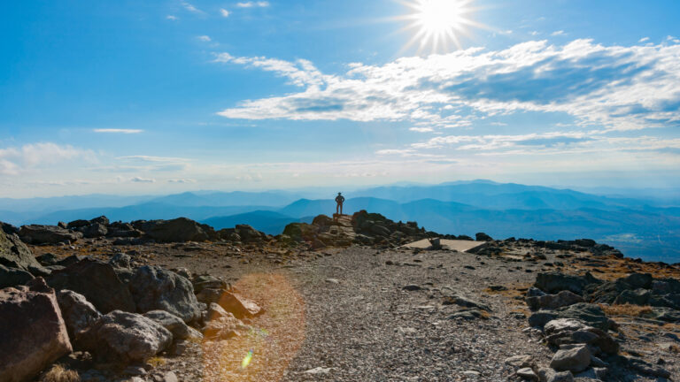 Man standing on the Mount Washington Summit