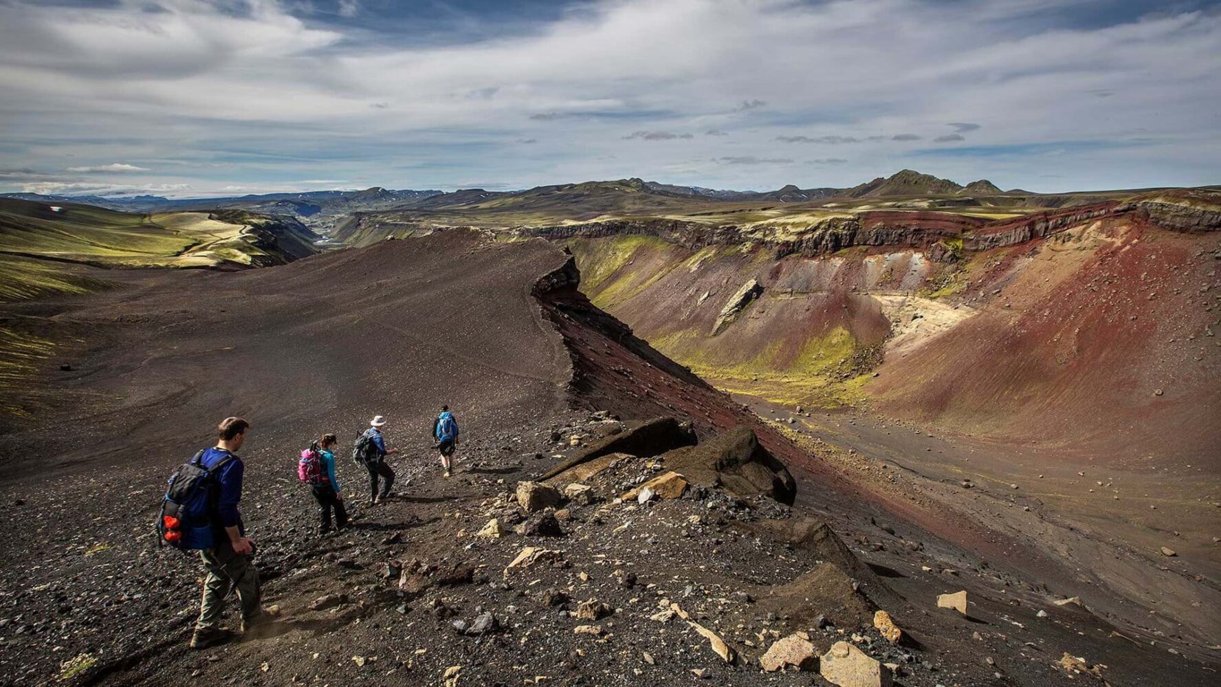 Hikers descending Iceland’s black sands