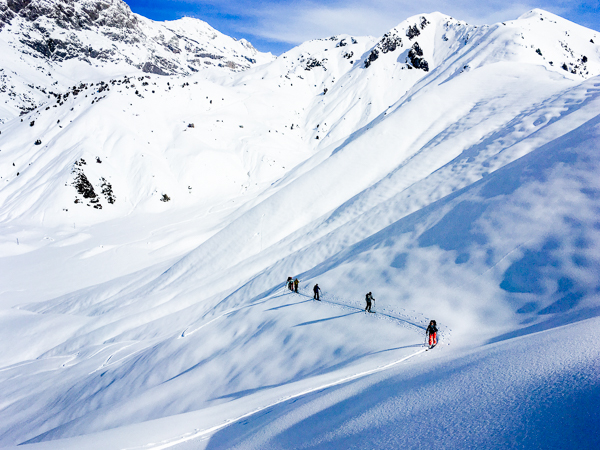 Some skiers ascending a slope in the Kyrgyzstan backcountry