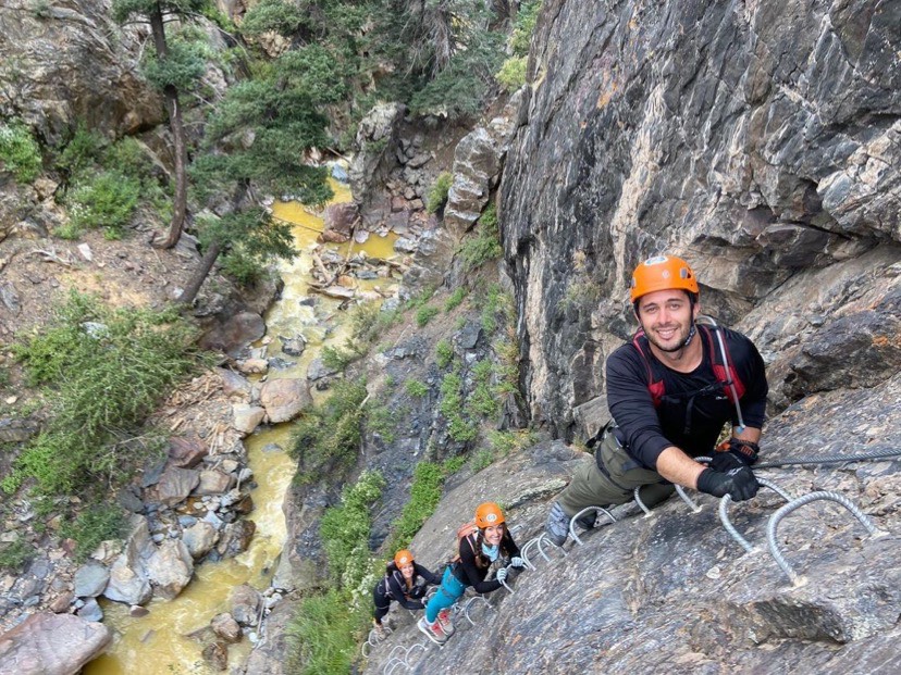 Adventurers posing on a ladder on the Ouray Via Ferrata