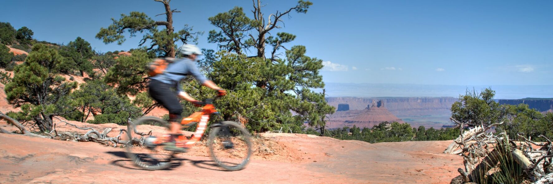 A rider speeding down the Porcupine Rim trail
