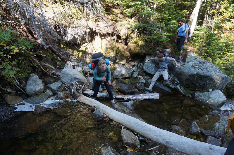 Hikers on a stream on the Presidential Traverse