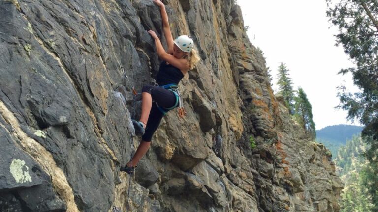 A woman climbing a cliff in Colorado