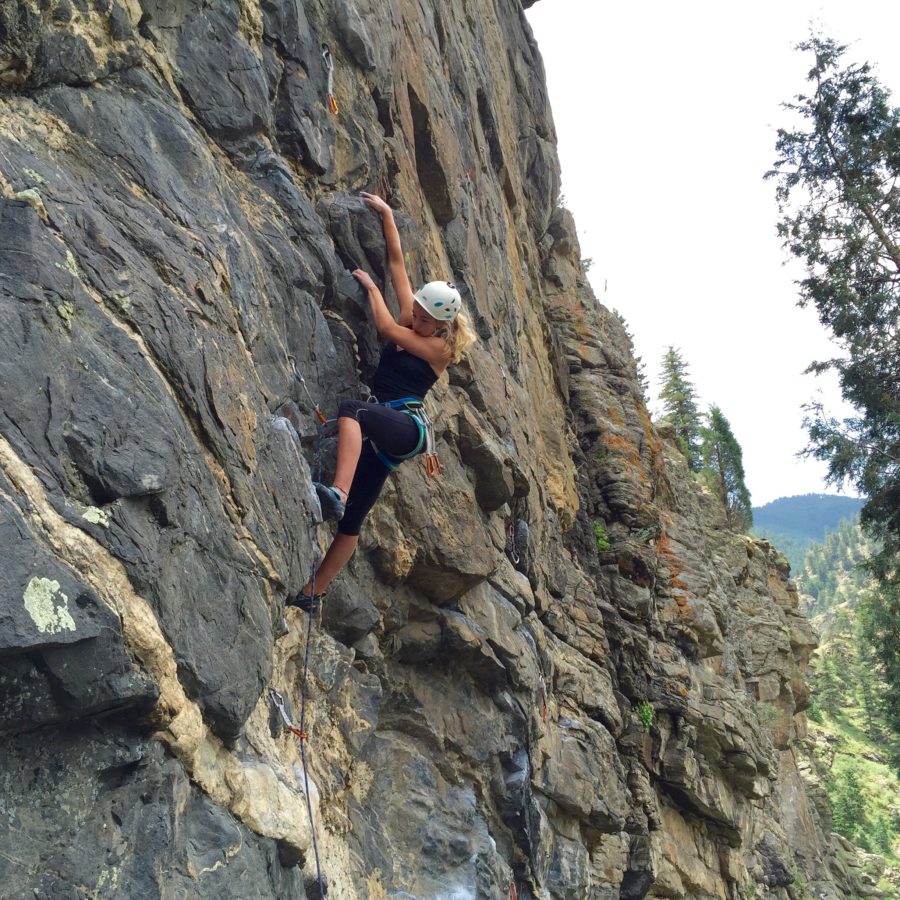 A woman climbing a cliff in Colorado