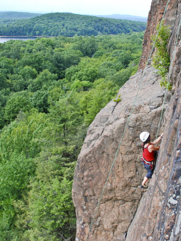 A woman climbing a cliff in Connecticut