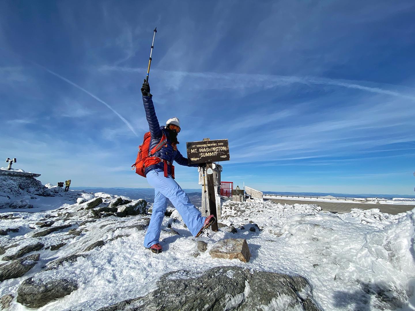 A hiker taking a picture on Mt. Washington Summit