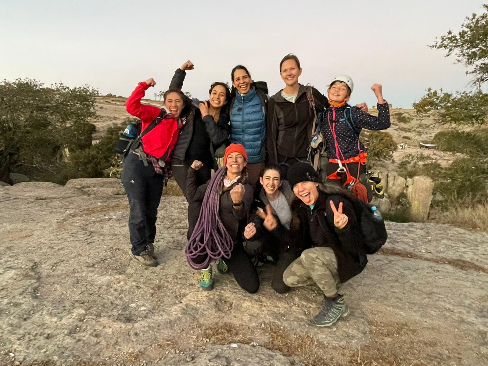 A group of women posing for a photo after successfully completing a course in rock climbing