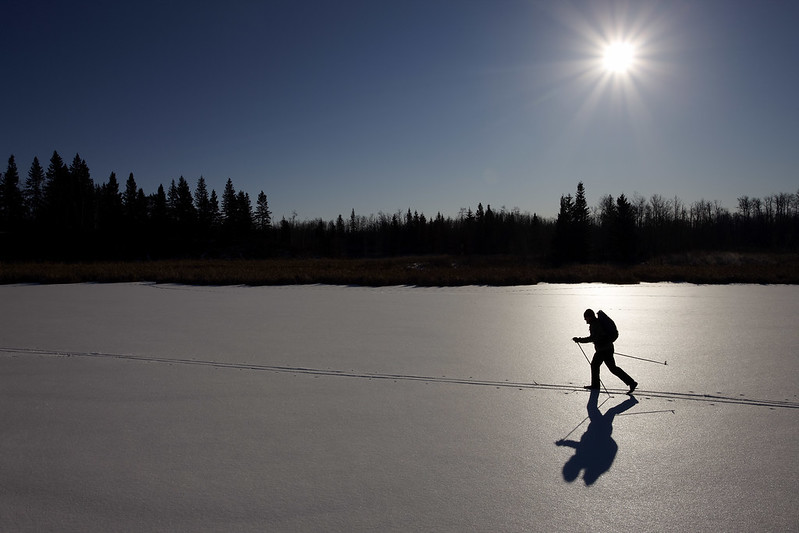 A mountaineer in shadow walking in Alberta