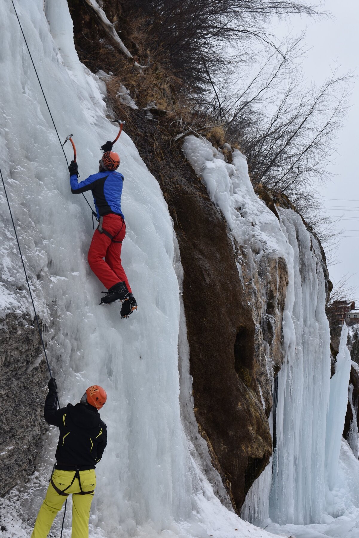Ice climber descending a waterfall in Aspen