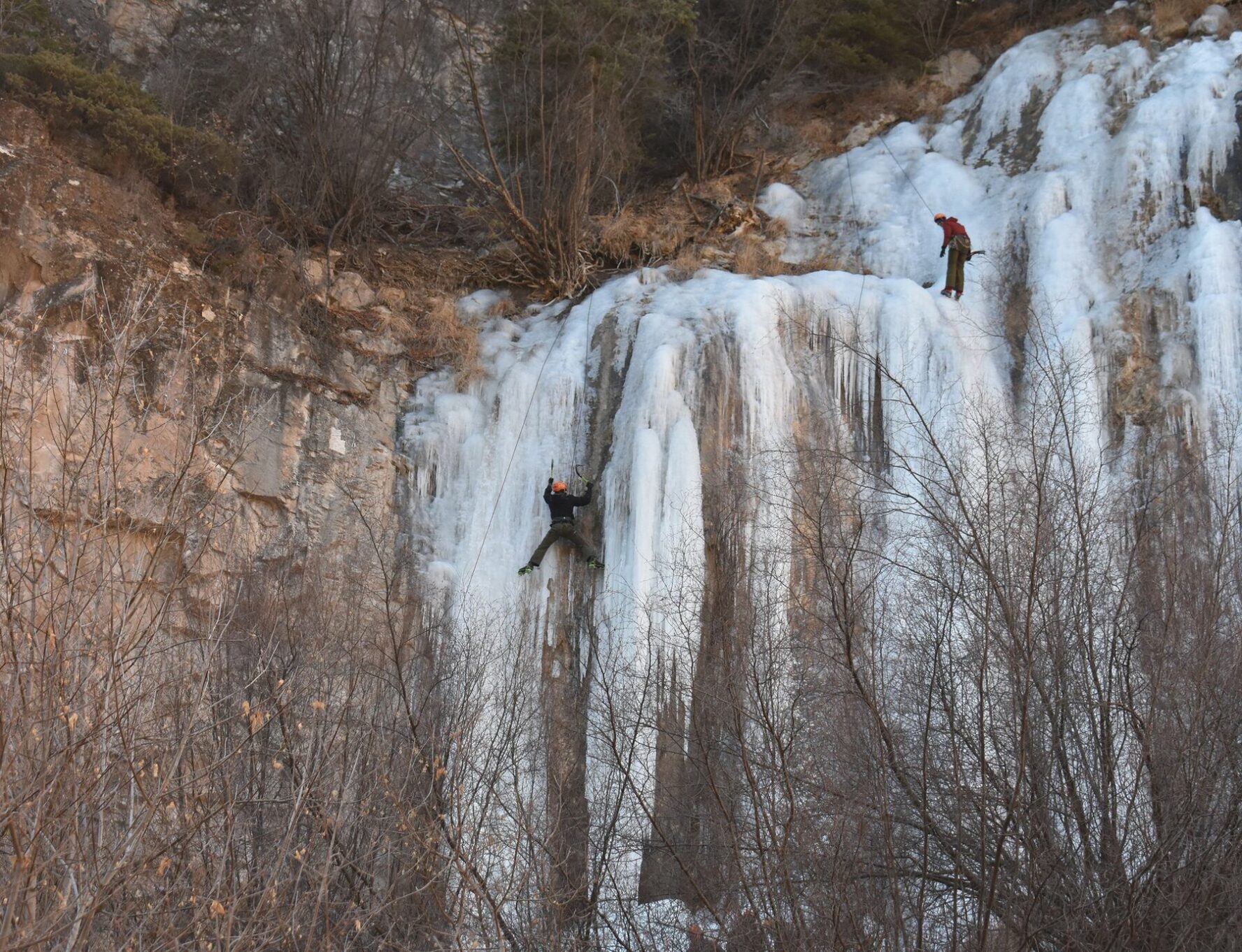 A climber near the top of a waterfall in Aspen