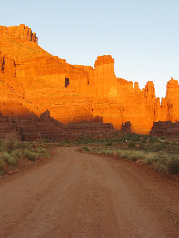 A climber ascending a tower in the Moab region