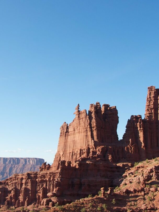 A climber ascending a tower in the Moab region