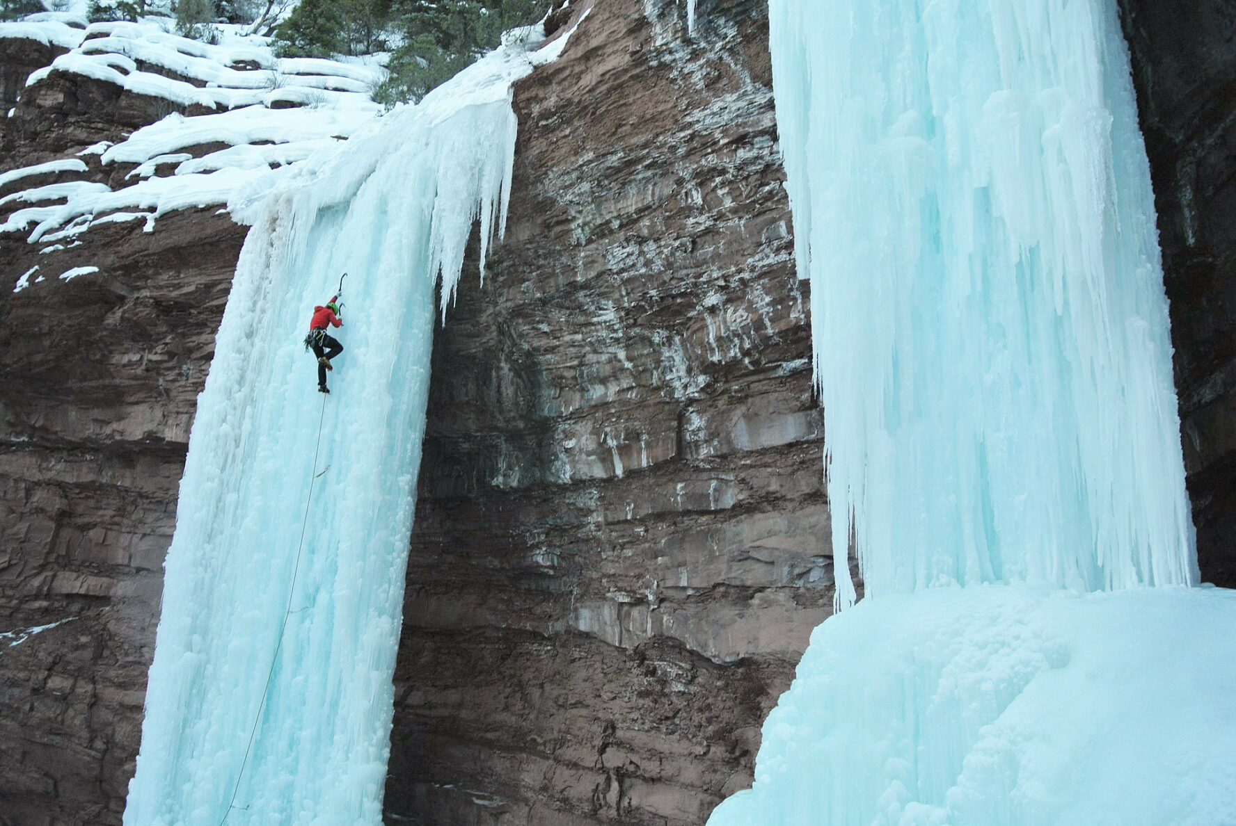 A climber on a frozen waterfall in Telluride