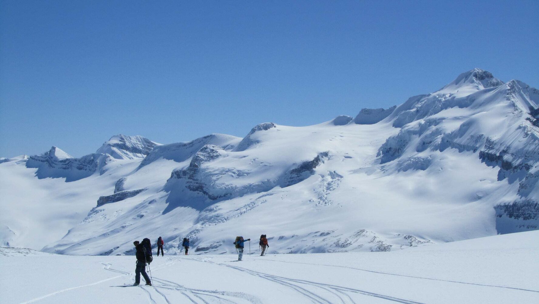 A group of people near a mountain on the Wapta Traverse