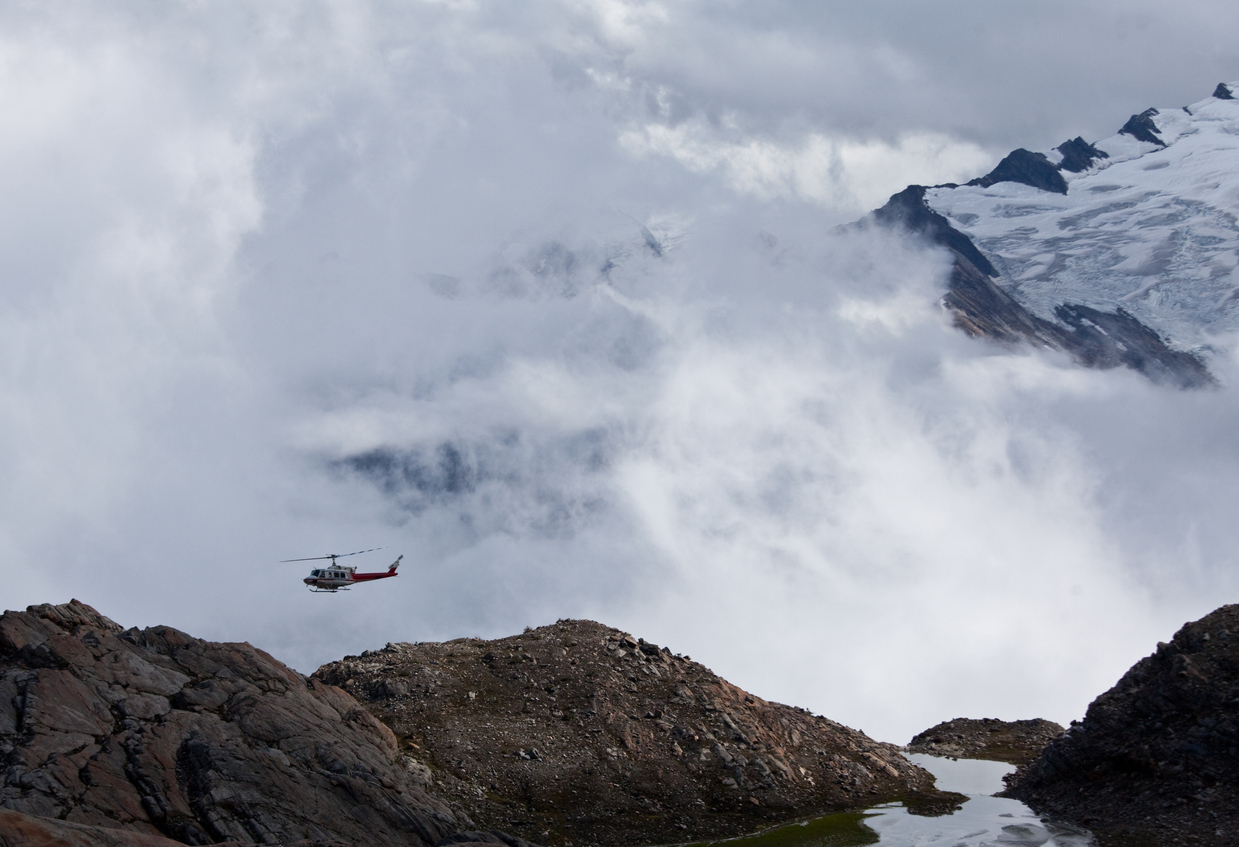 A helicopter flying above the Cariboo Mountains