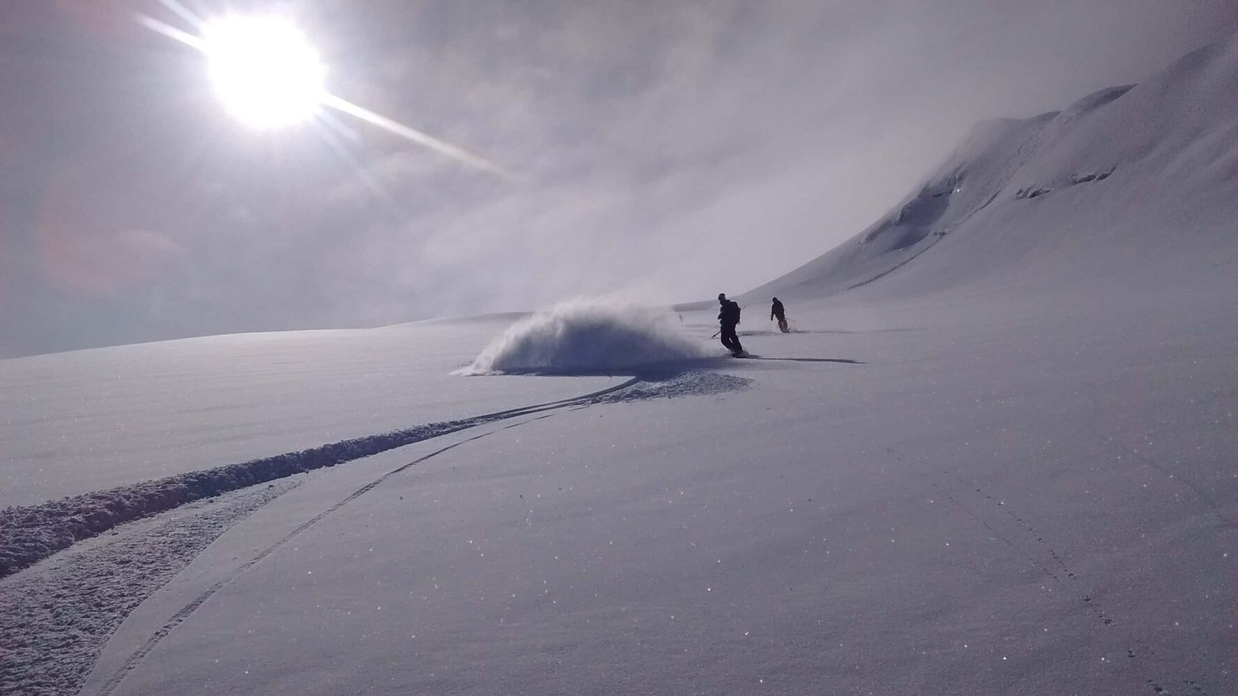 Skiers descending a slope in the Cariboo Mountains