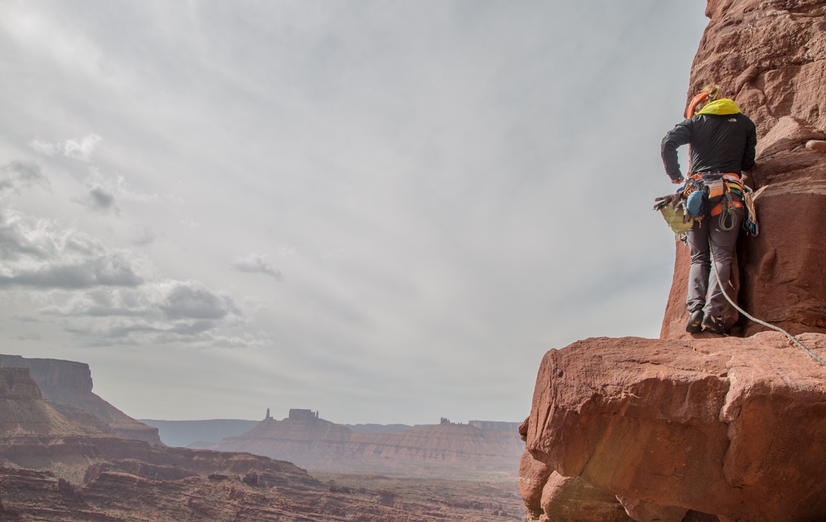 A crack climber on a ledge in Indian Creek