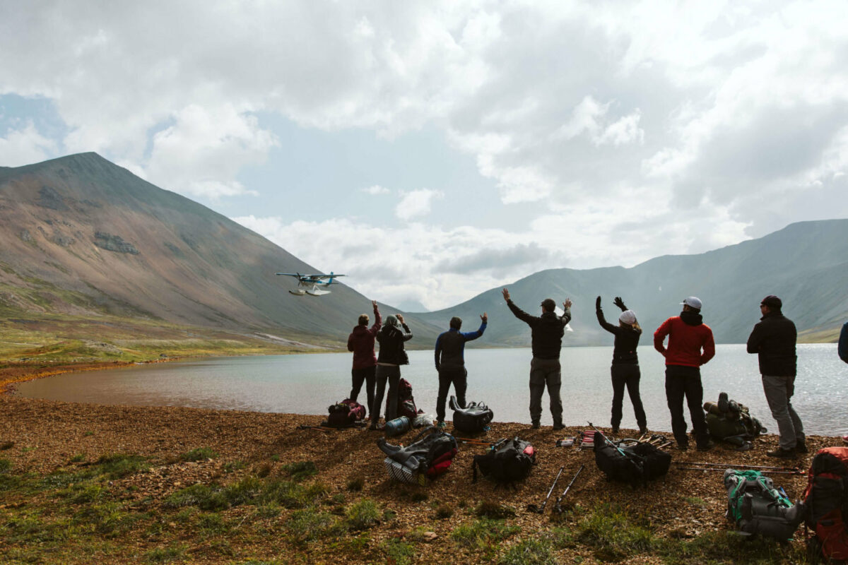 Fastpackers waiving to a plane in Lake Clark National Park
