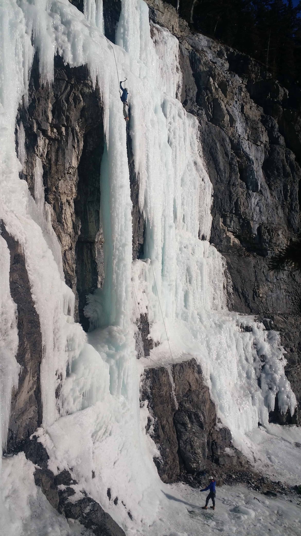An ice climber and a magnificent ice climbing location in the Canadian Rockies