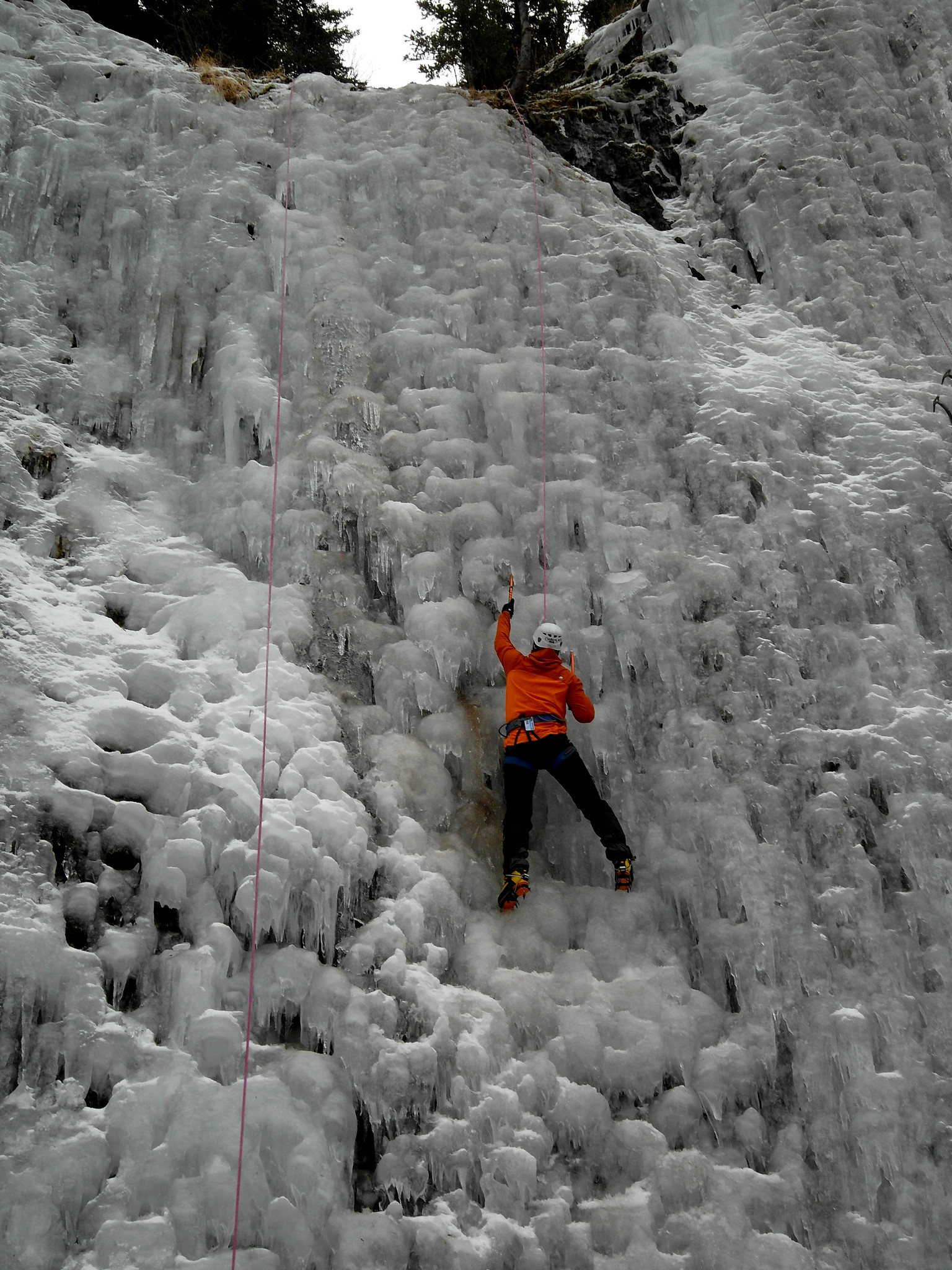 An ice climber surrounded by icy structures