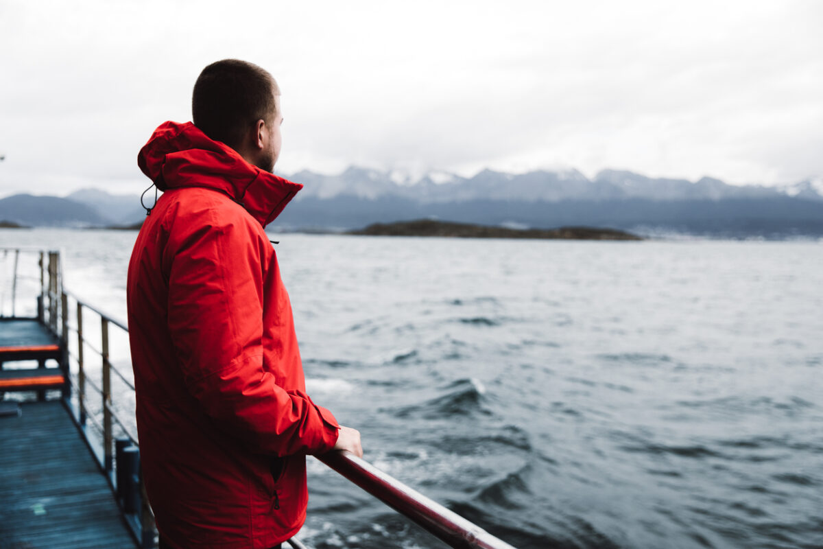 A man on a ship sailing down the Beagle Channel