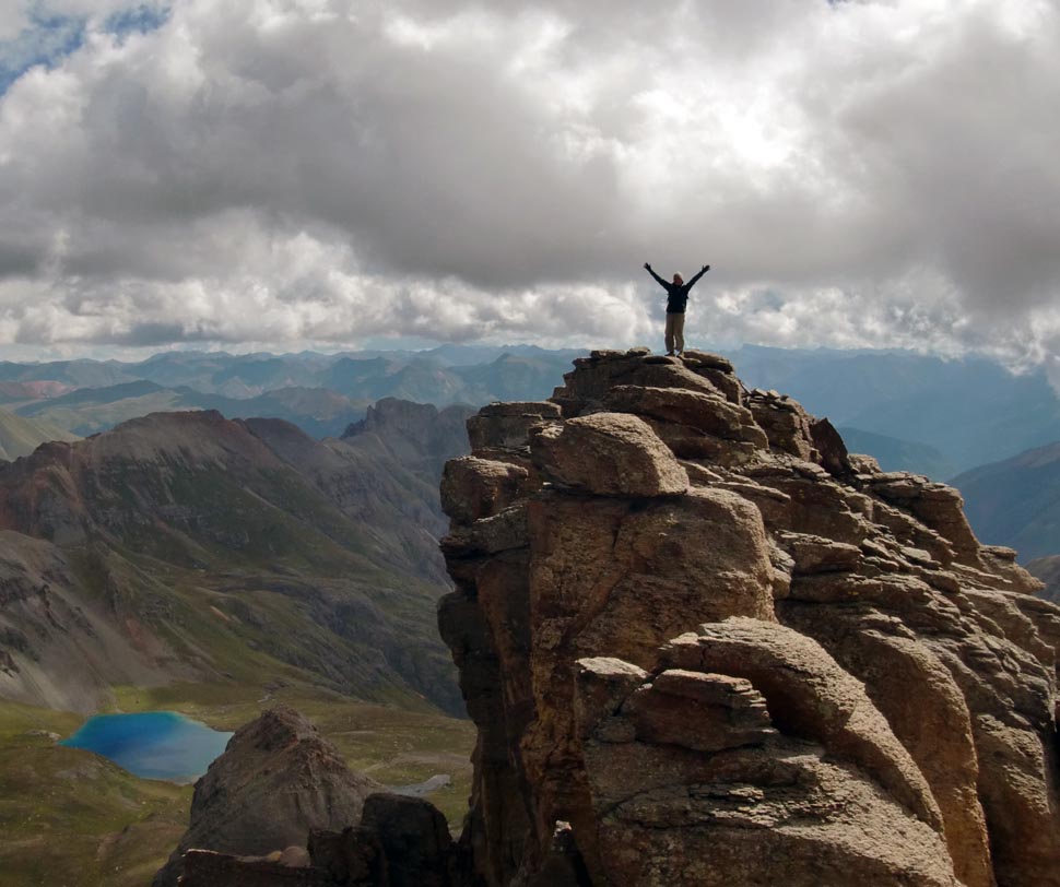 A climber at the peak of Pilot’s Knob