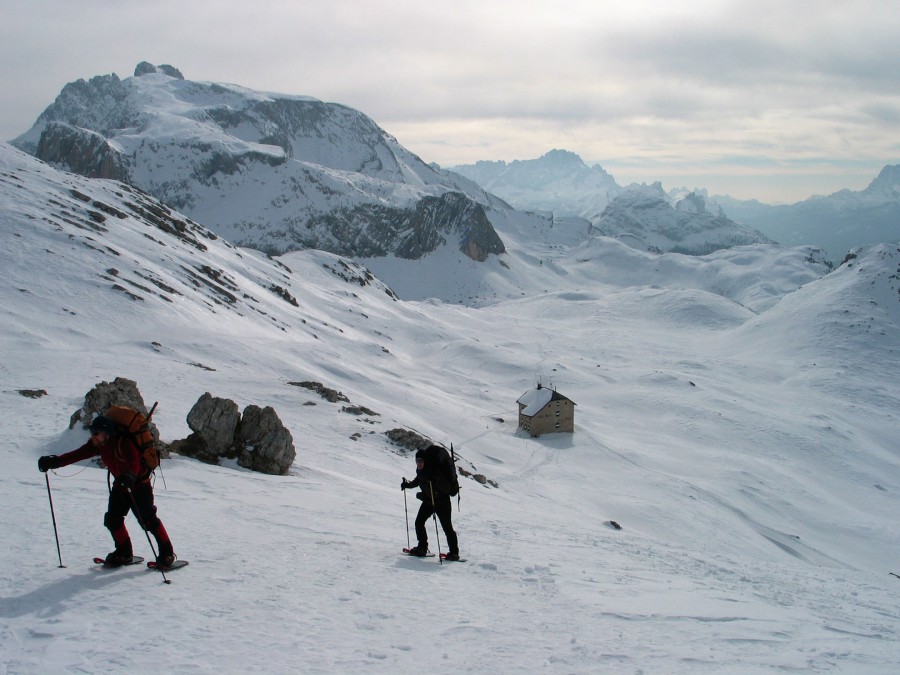 Snowshoers and a mountain hut