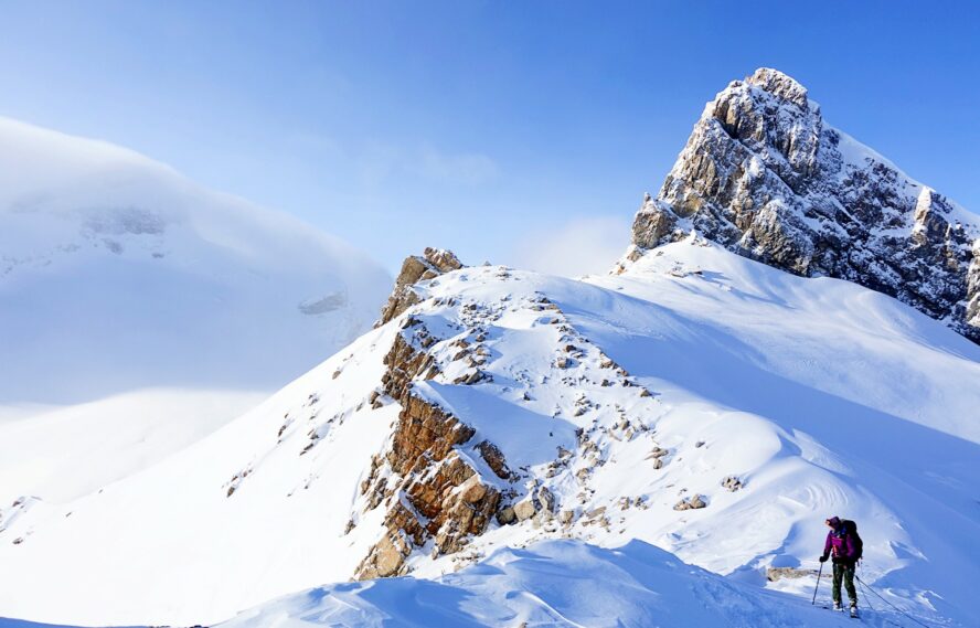Skier on the aerial traverse over Gordon-Rhondda Pass en route to the Guy Hut in the Canadian Rockies.