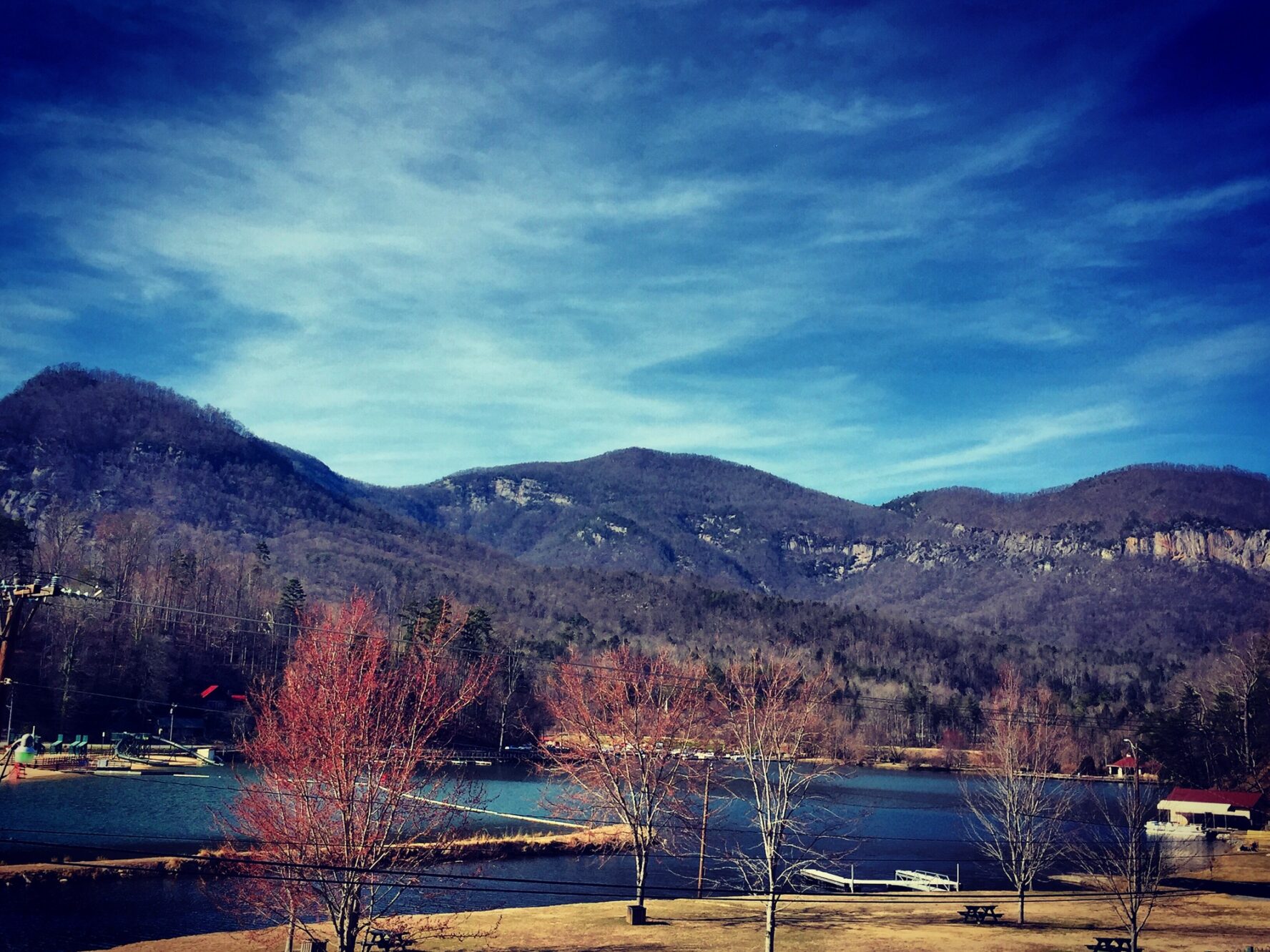 The Rumbling Bald crags as seen from Lake Lure in autumn.