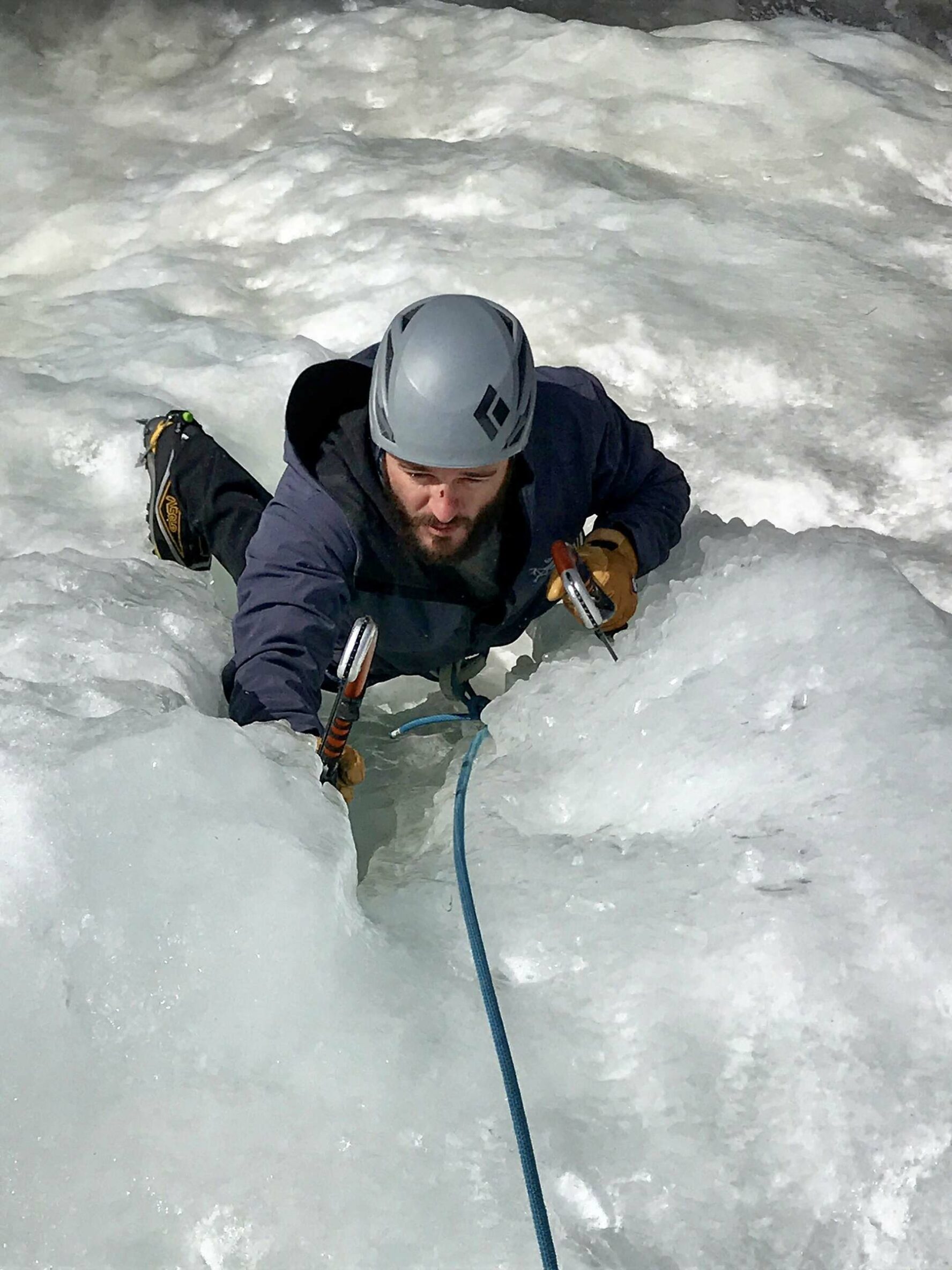 An ice climber ascending an icy wall in Colorado’s backcountry