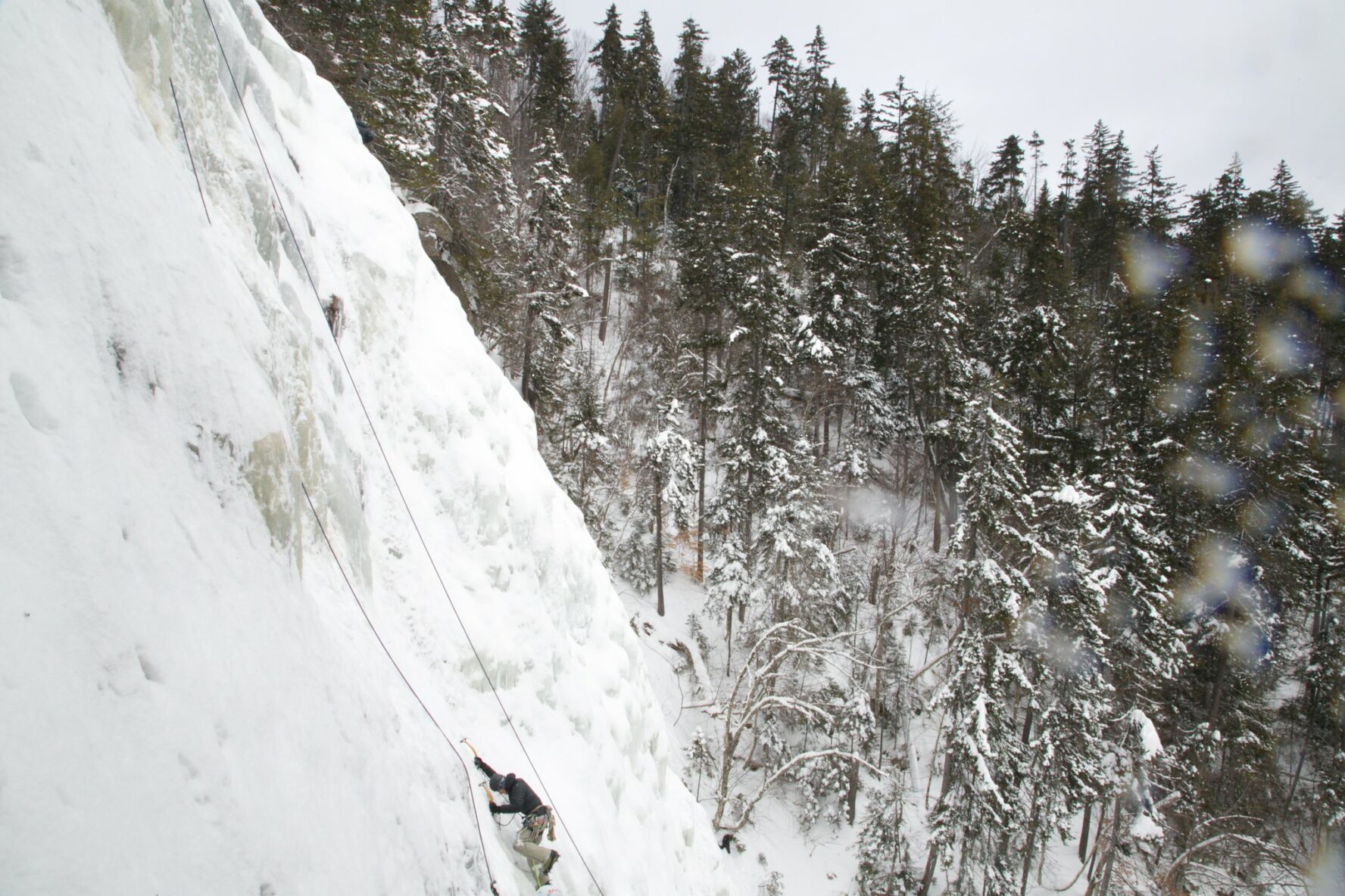 An ice climber climbing in New Hampshire