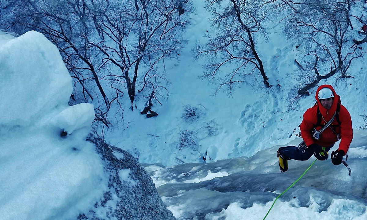 An ice climber on an icy structure in the Wasatch Mountains area