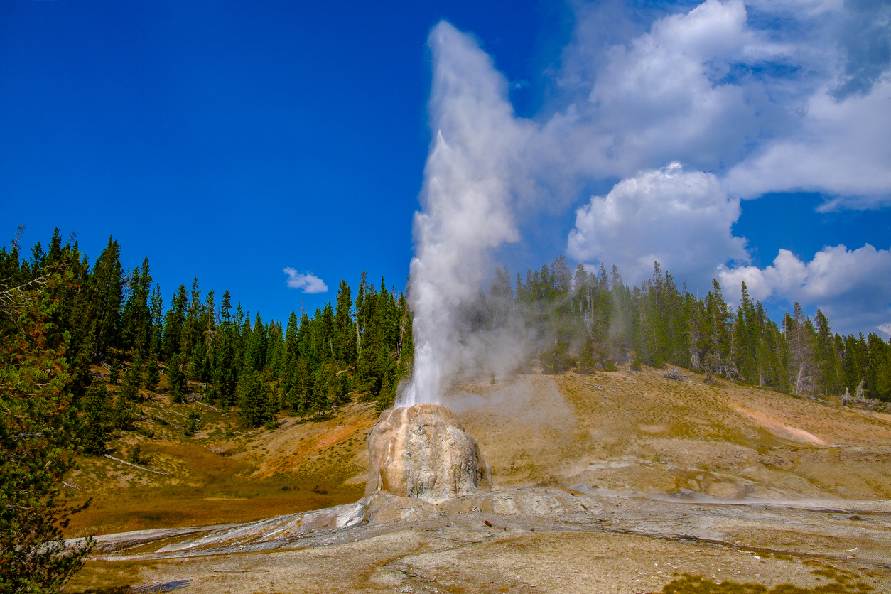 The Lone Star Geyser puts on quite a performance as it erupts for more than fifteen minutes at Yellowstone National Park. This picture shows it in full throttle.