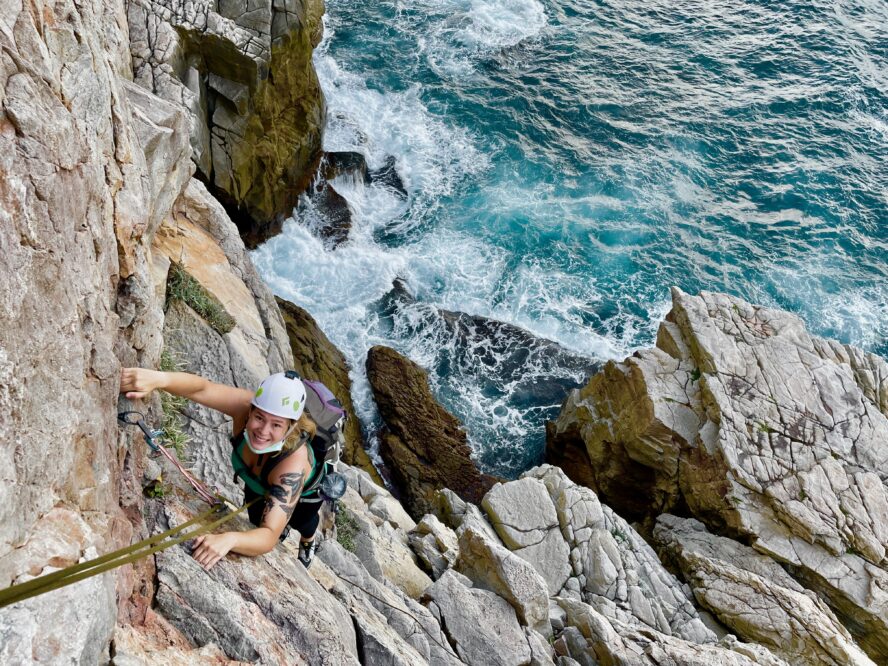 Climber above the roiling Pacific waters